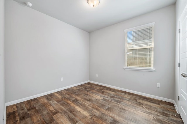 unfurnished room with dark hardwood / wood-style floors