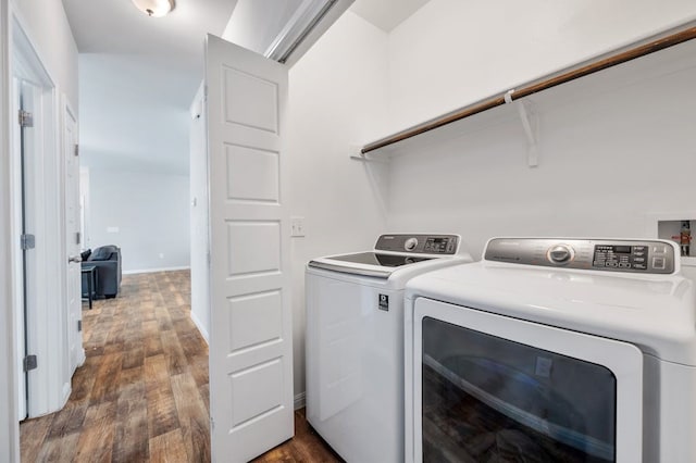 washroom with washing machine and dryer and dark hardwood / wood-style flooring