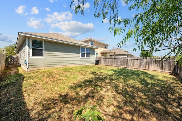 rear view of property with a lawn