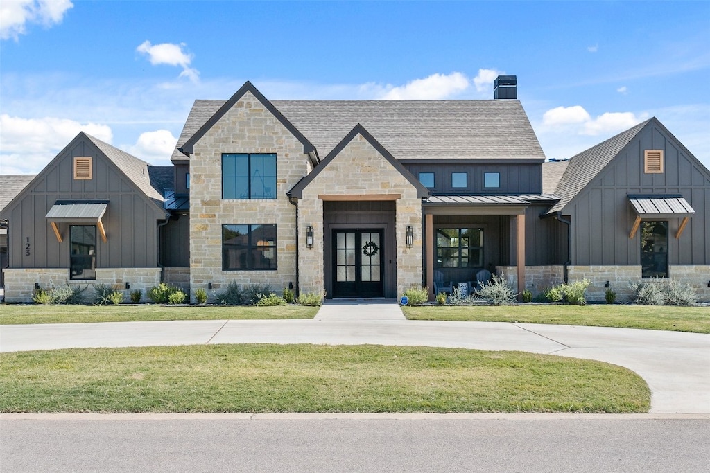 modern farmhouse style home with a front yard