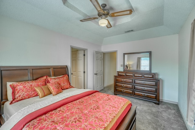 bedroom featuring a textured ceiling, carpet flooring, and ceiling fan