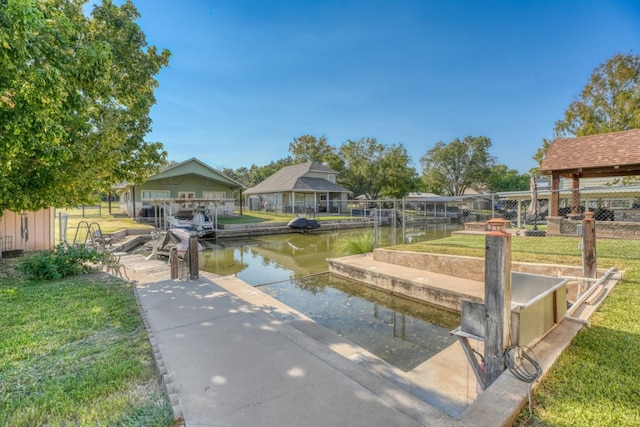 dock area with a water view and a lawn