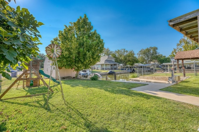 view of yard featuring a water view and a playground