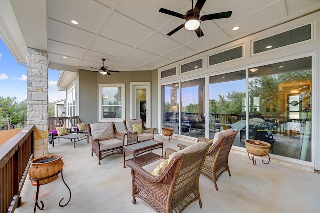 view of patio with an outdoor living space and ceiling fan