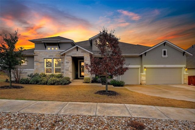 view of front facade with a garage and a yard