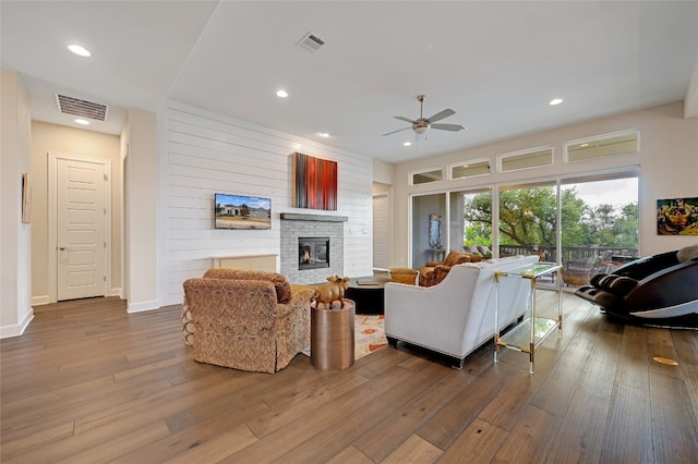 living room with wood-type flooring and ceiling fan