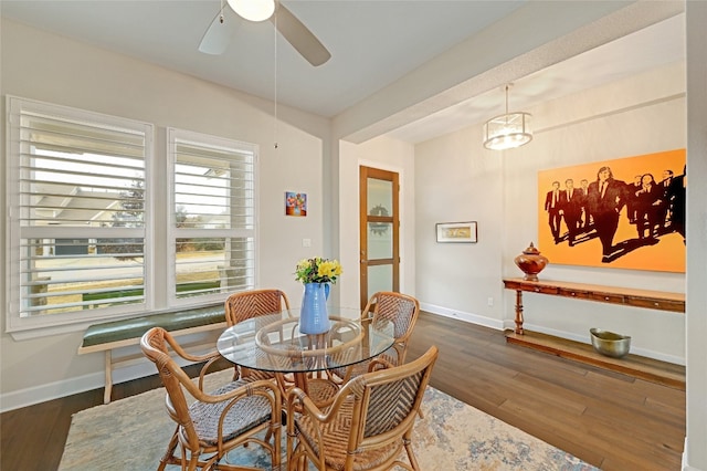 dining space with dark hardwood / wood-style floors and ceiling fan