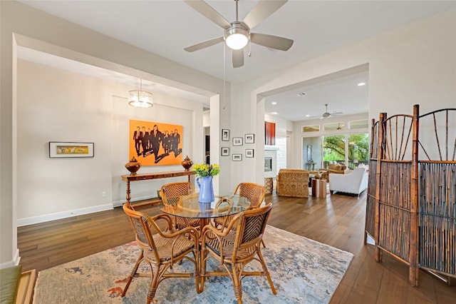 dining room featuring ceiling fan and dark wood-type flooring