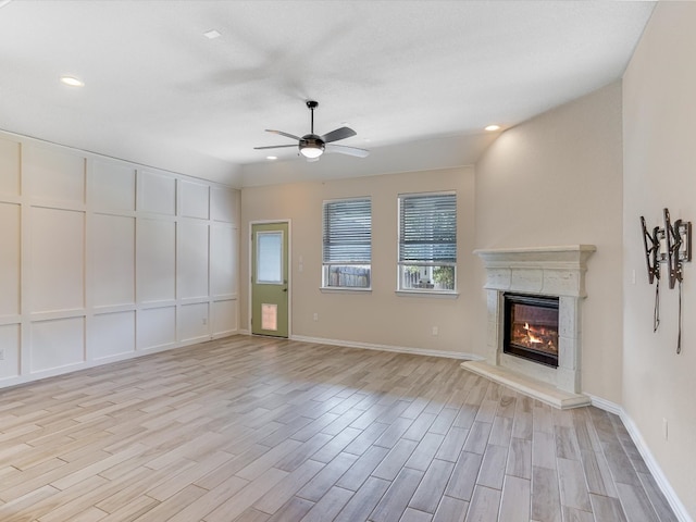 unfurnished living room with light wood-type flooring and ceiling fan