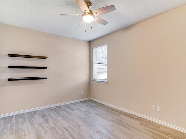 empty room with ceiling fan and light wood-type flooring