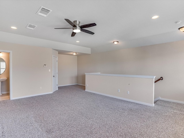 carpeted spare room with ceiling fan