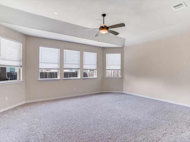 spare room with carpet flooring, a textured ceiling, and ceiling fan