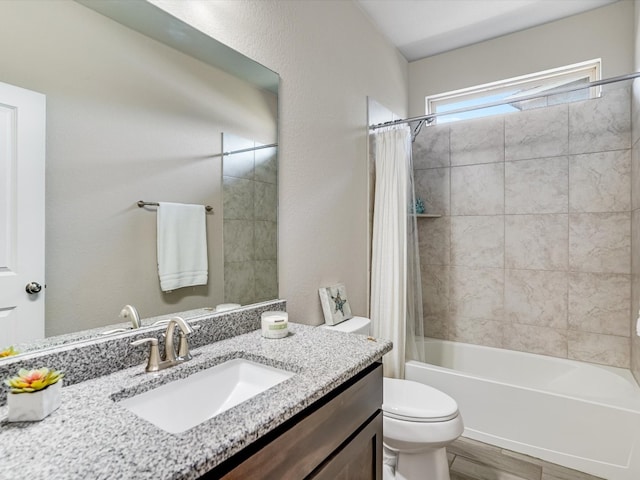 full bathroom with vanity, hardwood / wood-style floors, toilet, and shower / tub combo with curtain