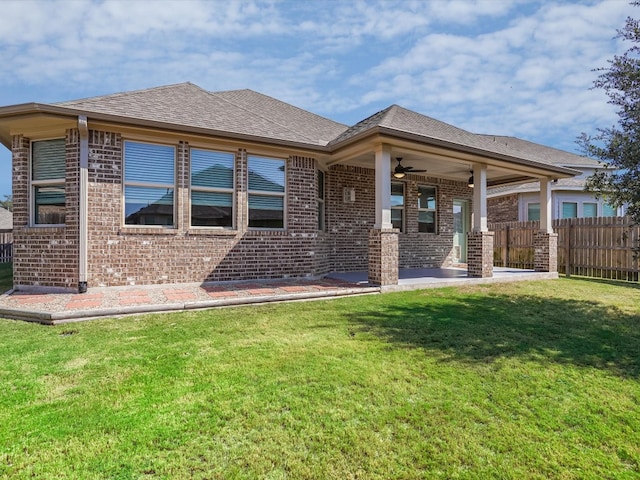 back of house with ceiling fan, a lawn, and a patio