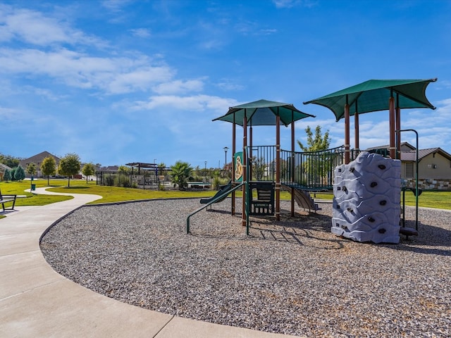 view of playground with a lawn