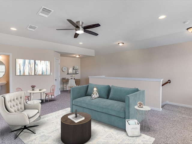 carpeted living room with ceiling fan