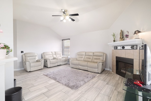 living room featuring a fireplace, vaulted ceiling, and ceiling fan