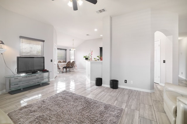 unfurnished living room featuring ceiling fan, lofted ceiling, and light wood-type flooring