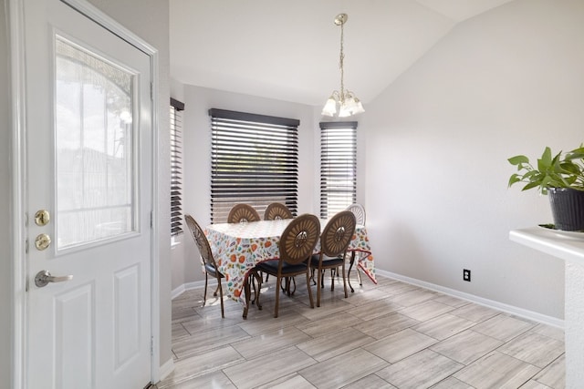 dining room featuring a notable chandelier and vaulted ceiling