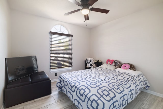 bedroom with ceiling fan and wood-type flooring