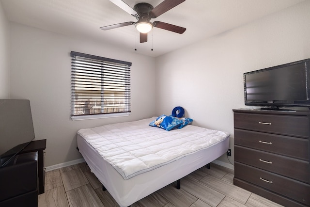 bedroom with ceiling fan and light hardwood / wood-style flooring