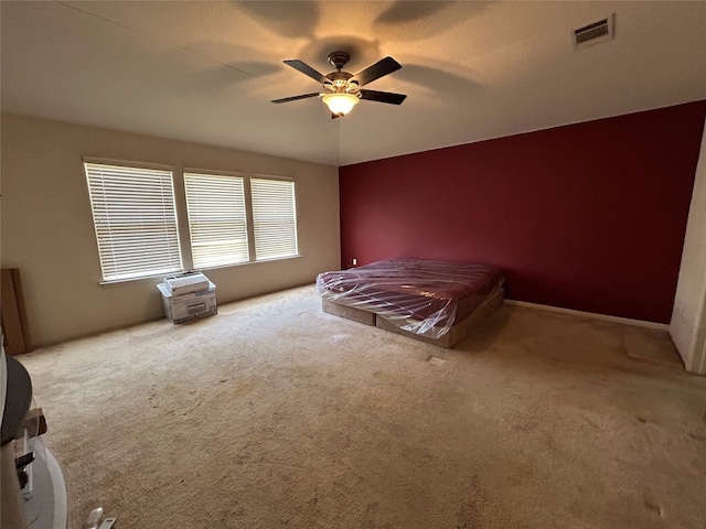 unfurnished bedroom featuring light carpet and ceiling fan