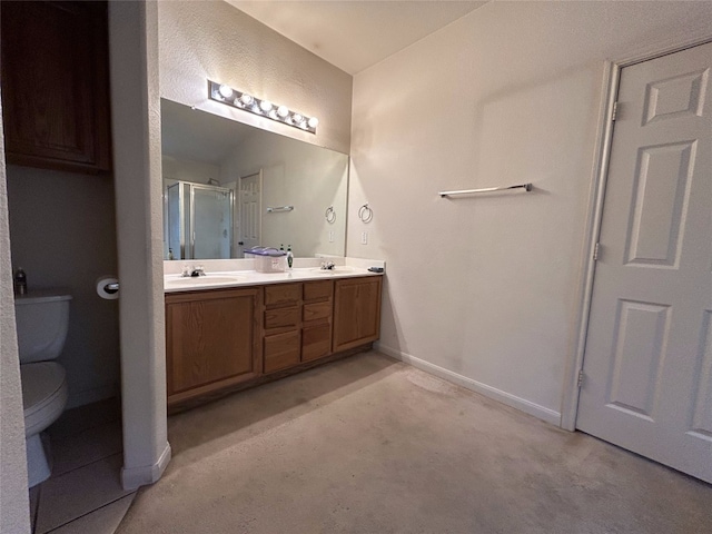 bathroom with a shower with door, vanity, and toilet