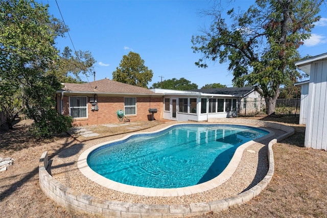 view of swimming pool with a sunroom