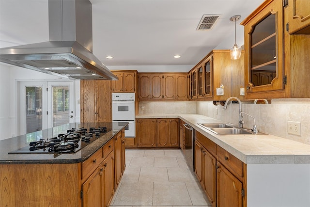 kitchen featuring light tile patterned floors, sink, island exhaust hood, backsplash, and stainless steel appliances