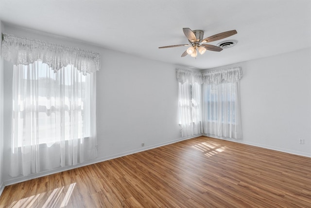 empty room with wood-type flooring and ceiling fan