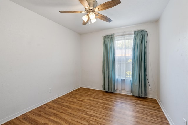 empty room featuring ceiling fan and hardwood / wood-style floors