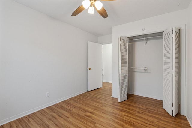 unfurnished bedroom featuring ceiling fan, light wood-type flooring, and a closet