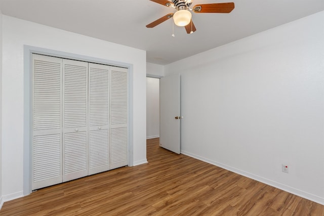 unfurnished bedroom featuring a closet, light wood-type flooring, and ceiling fan