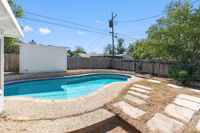 view of pool with a storage unit