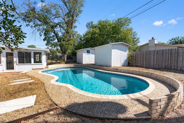 view of pool with a shed