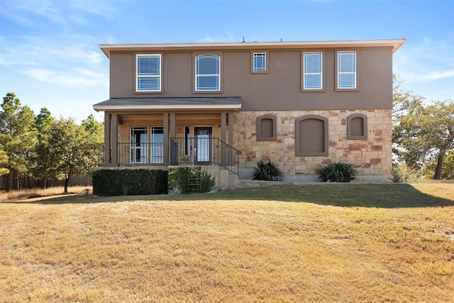 view of front of home with a porch and a front lawn