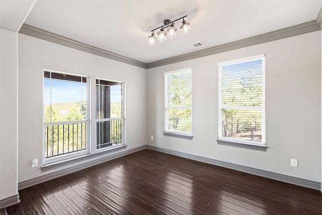 empty room featuring ornamental molding and dark hardwood / wood-style floors