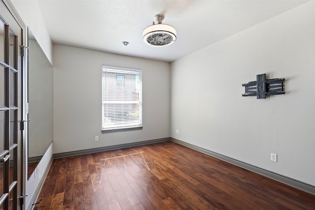 unfurnished room with dark hardwood / wood-style floors