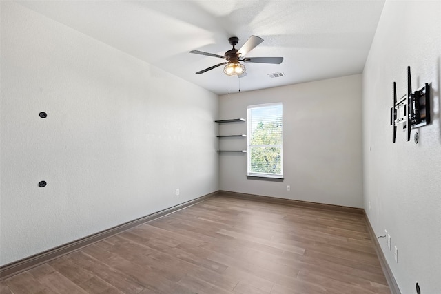 empty room featuring light hardwood / wood-style flooring and ceiling fan