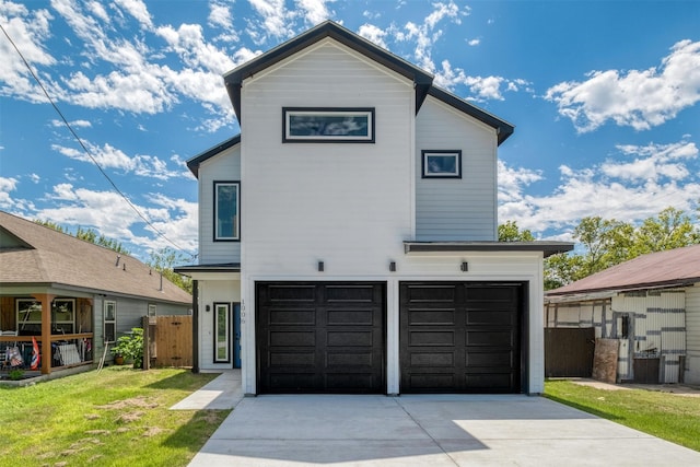 view of front of home featuring a garage and a front yard