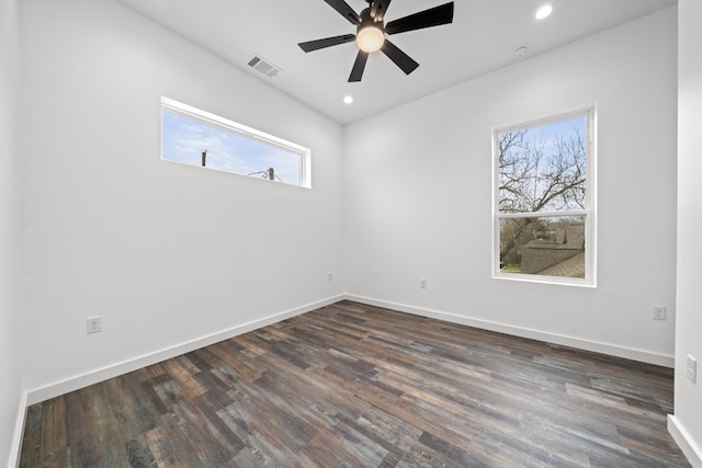 spare room with ceiling fan and dark hardwood / wood-style flooring