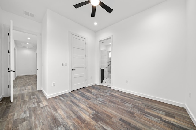 spare room featuring dark hardwood / wood-style flooring and ceiling fan