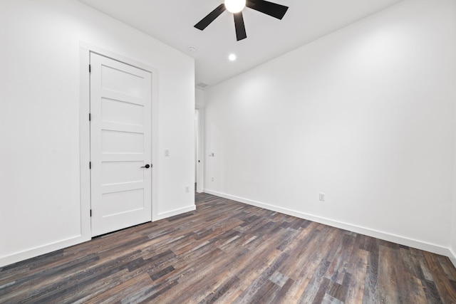 empty room with dark hardwood / wood-style flooring and ceiling fan