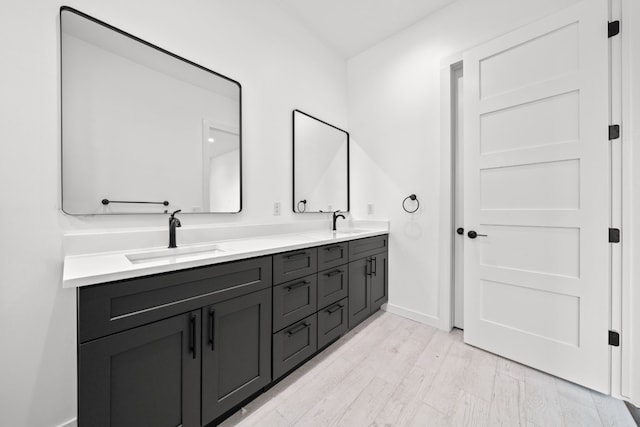 bathroom with vanity and hardwood / wood-style flooring