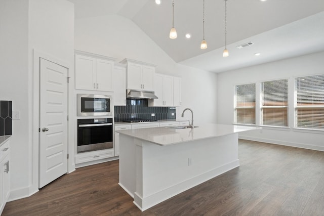 kitchen with a kitchen island with sink, sink, white cabinetry, appliances with stainless steel finishes, and dark hardwood / wood-style flooring