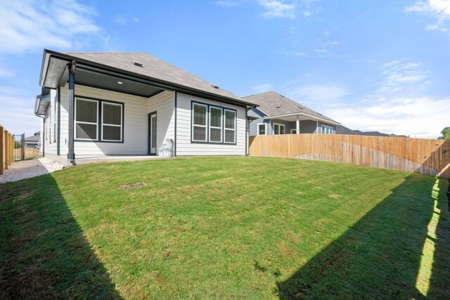 back of house with a lawn