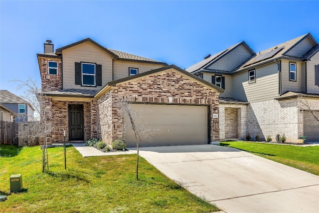 view of property featuring a garage and a front lawn