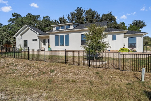 rear view of property featuring a yard