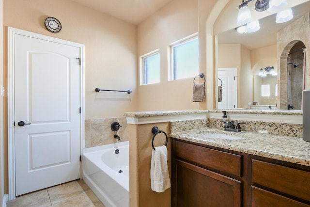 bathroom featuring tile patterned flooring, shower with separate bathtub, and vanity