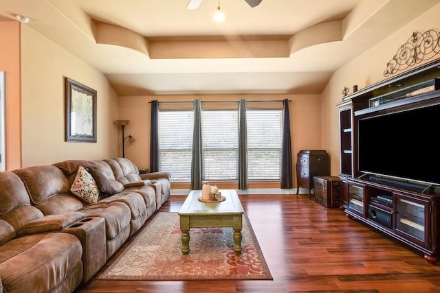 living room featuring dark wood-type flooring, vaulted ceiling, and ceiling fan